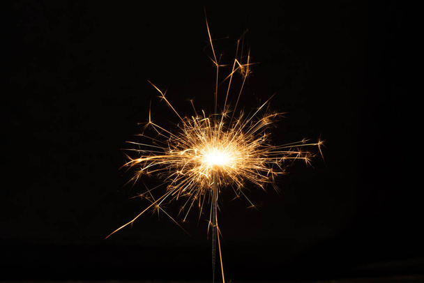 Sparkler background. Christmas and new year sparkler holiday background. bengal light on the black background - 写真・画像