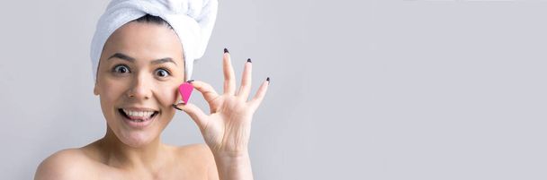 Beauty portrait of woman in white towel on head with a sponge for a body in view of a pink heart. Skincare cleansing eco organic cosmetic spa relax concept. - Фото, зображення