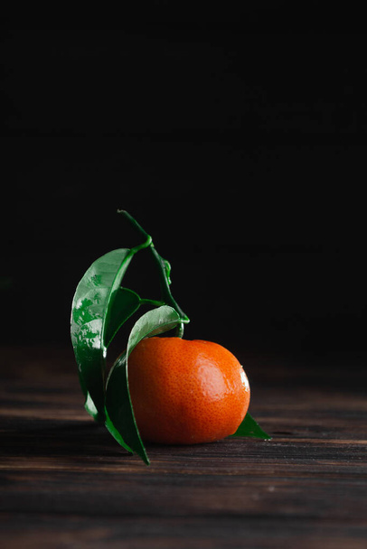 Fresh tangerines with leaves on a wooden old background - Photo, Image