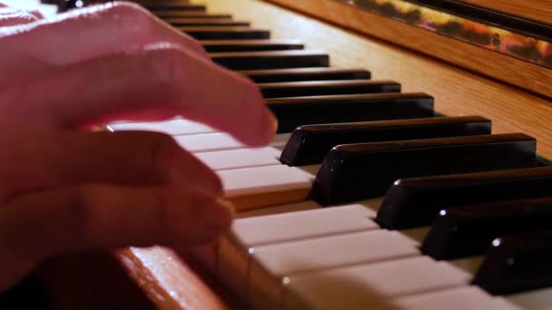 zbliżenie wideo człowieka gra na fortepianie z podświetleniem - Materiał filmowy, wideo