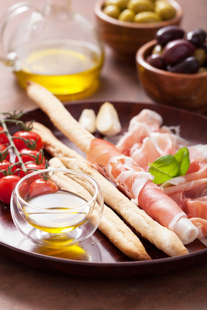 italian prosciutto ham grissini bread sticks tomato olive oil - Photo, Image