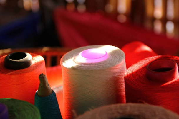 cień świetlny na szpulach przędzy na koszu bambusowym - Zdjęcie, obraz