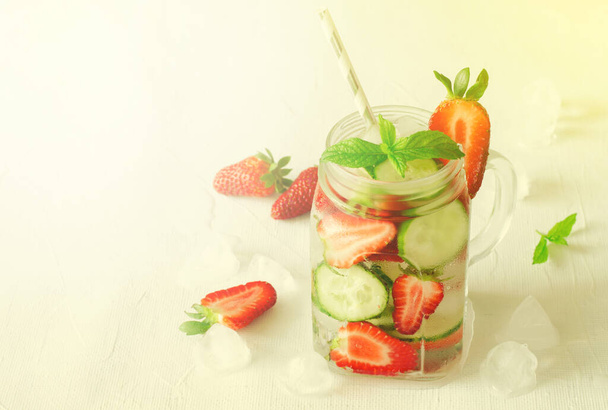 Summer refreshing iced drinks with cucumber and strawberry on white background - Zdjęcie, obraz