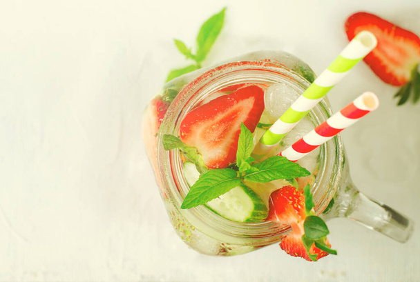 Summer refreshing iced drinks with cucumber and strawberry on white background - Fotografie, Obrázek