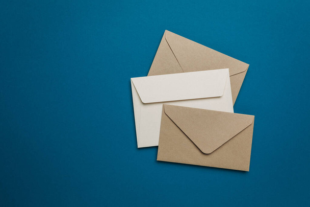 Mail envelopes on blue background, paper letter. Newsletter concept. - Photo, Image