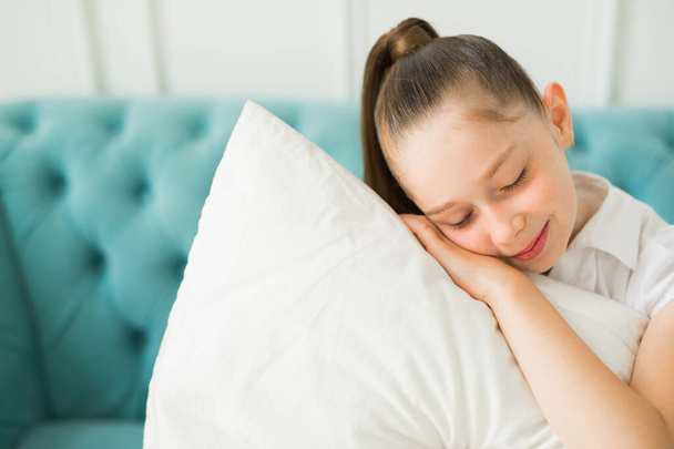 beautiful young teenager girl with a pillow - Fotografie, Obrázek
