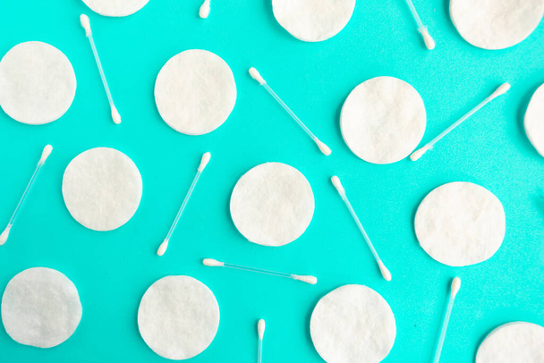 Cotton sponges and cotton buds pattern on blue background, minimal concept - 写真・画像