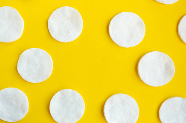 Cotton sponges pattern on bright yellow background, minimal concept, copy space - Фото, изображение