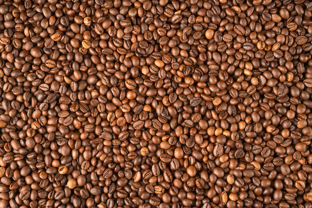 Raw coffee beans covered surface close up. Background and texture - Zdjęcie, obraz