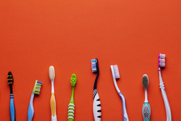Toothbrush isolated in orange background. Health Care. - Foto, imagen