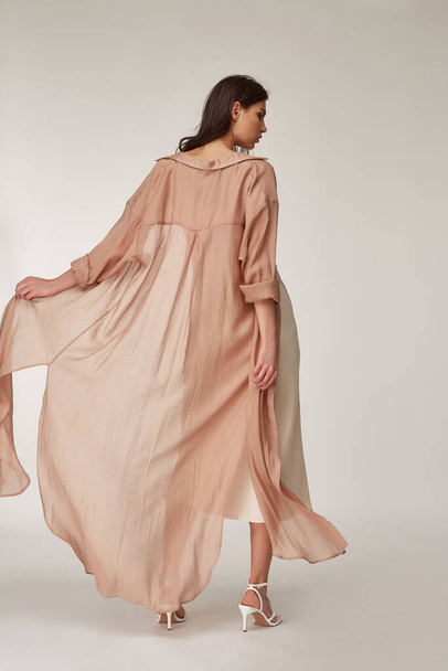 Beautiful woman fashion model makeup brunette hair perfect body shape tanned skin wear clothes summer collection organic silk dress and long shirt cape stylish sandals shoes, accessory romantic. - Foto, afbeelding
