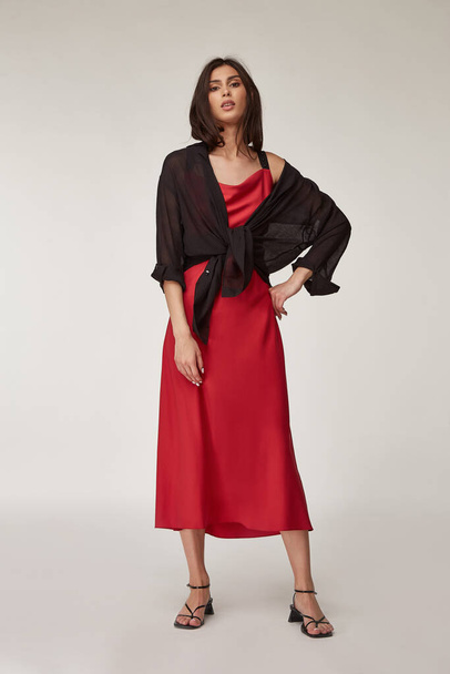 Fashion pretty woman beautiful makeup perfect body shape tanned skin wear clothes summer collection organic textile black cotton shirt, red silk dress stylish sandals shoes, accessory casual romantic. - 写真・画像