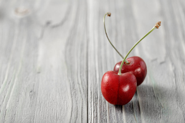 Fresh ripe garden cherries cherry closeup on a wooden aged table.  Backrgound with copy space - Photo, Image