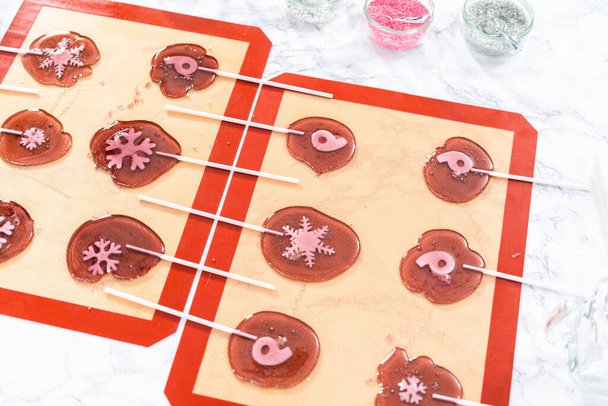 Making homemade berry flavor lollipops with snowflakes. - Photo, Image