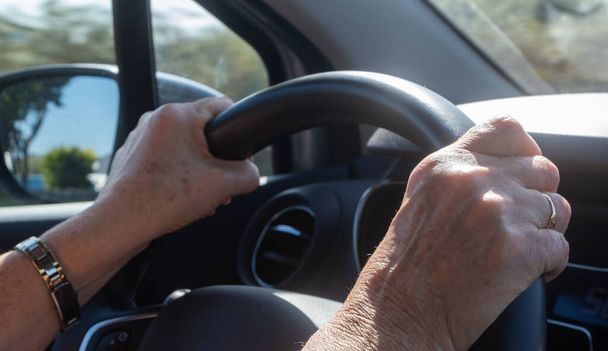 Hands of a woman on a steering wheel - Fotó, kép