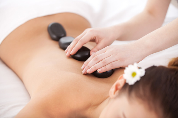 Woman lying on front while massage therapist massaging - Фото, изображение