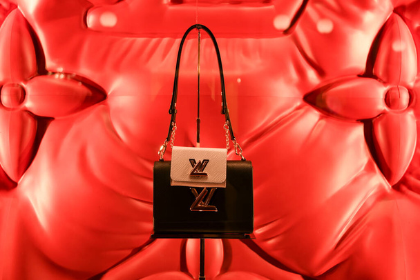 Milan, Italy - January 11, 2020: Louis Vuitton black purse with a mini pink purse attached display - Foto, Imagen