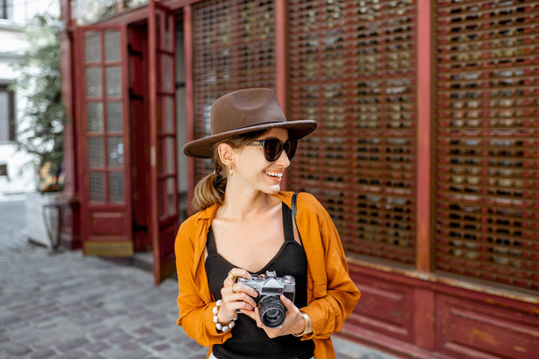 Stylish woman with photo camera outdoors - Foto, afbeelding