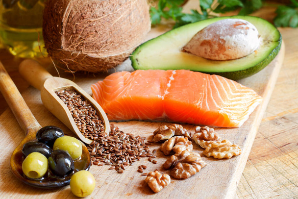 Healthy food. Products with healthy fats on wooden board - Фото, зображення