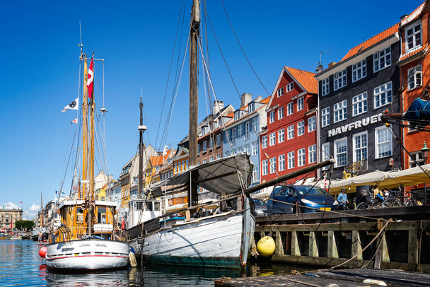 Pair of masted wooden sailing boat in the canal in the Nyhavn district of Copenhagen, Denmark on 18 July 2019 - 写真・画像