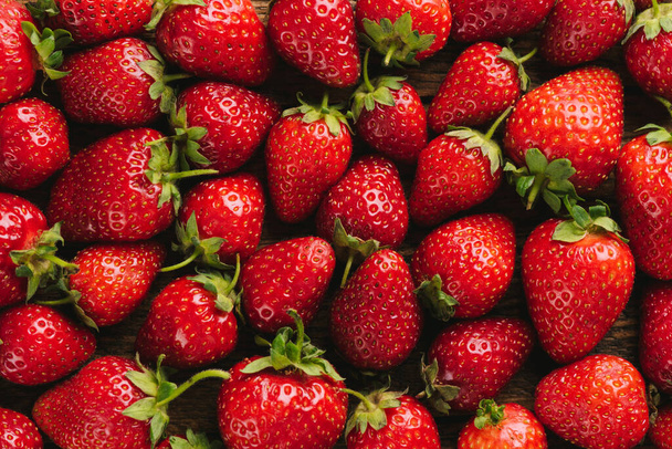 Strawberries as background. Freshly picked red strawberries. Fruit wallpaper - Fotoğraf, Görsel