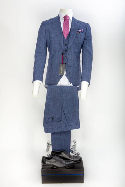 Men's jacket, shirt and tie on lifeless model. Suitcase concept. - Photo, Image