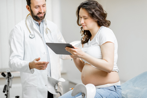 Orvos terhes nővel egy orvosi konzultáció során - Fotó, kép