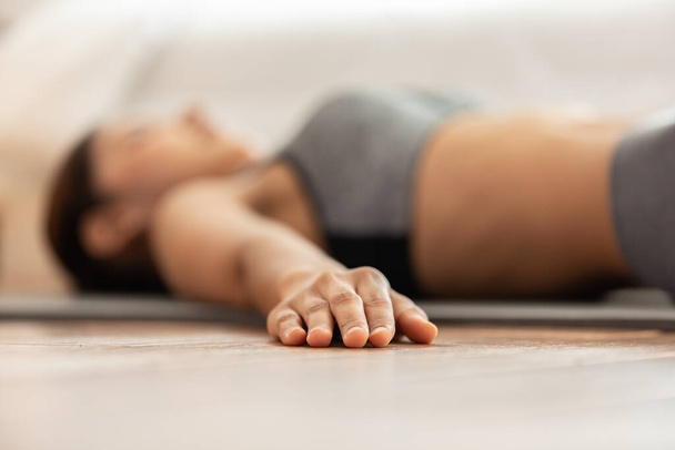 Close up hand of Asian woman practice yoga Dead Body or Savasana pose with meditation smile at home Feeling so comfortable and relax,Healthcare Concept - Foto, immagini