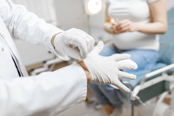Doctor wearing medical gloves before a procedure - Photo, Image