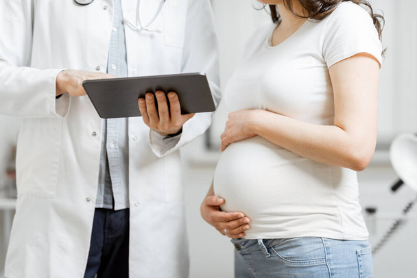 Médico con mujer embarazada durante una consulta médica - Foto, Imagen