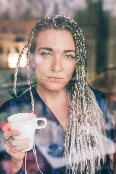 Портрет взрослой женщины с чашкой кофе - беззаботный портрет взрослой женщины с чашкой кофе, смотрящей в камеру
  - Фото, изображение