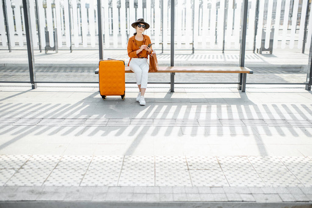 Female traveler at the public transport stop - Photo, Image