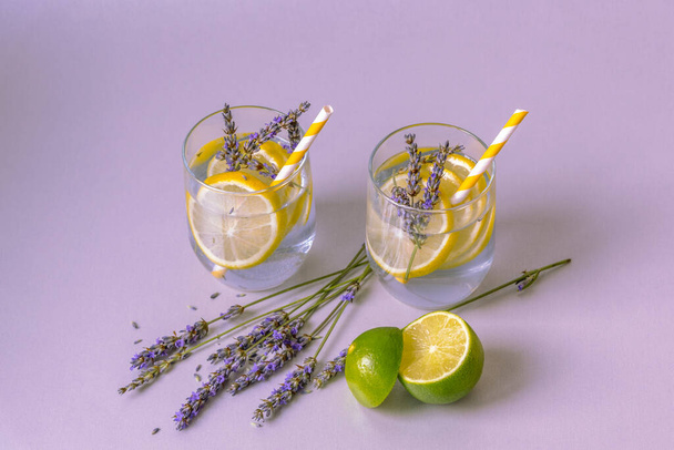 Glasses with lavender lemonade on light lilac table - Foto, imagen