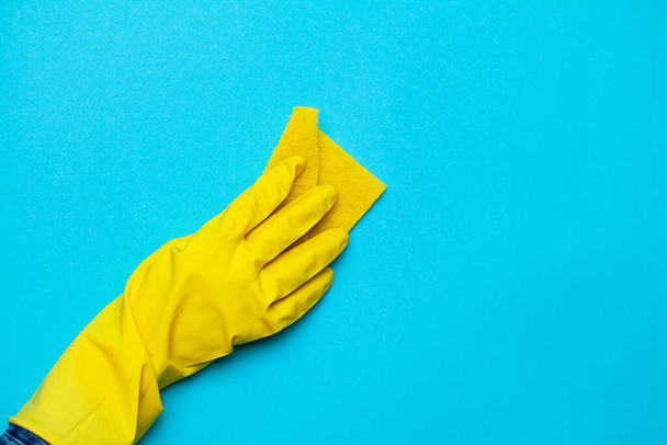 Закройте руку в желтой перчатке для чистки
 - Фото, изображение