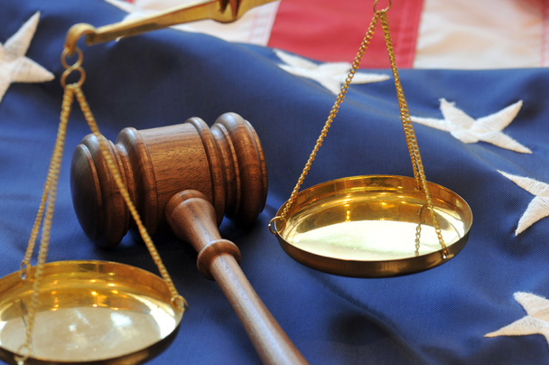 Gavel and scales atop flag background - Photo, Image