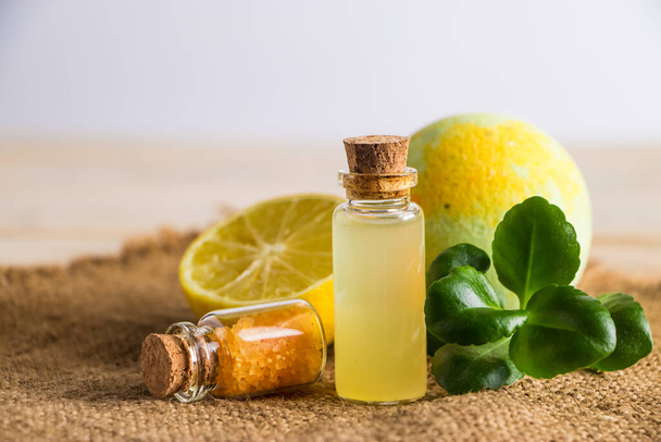 Health care concept. Organic cosmetics with lemon. Product for spa and aromatherapy. Natural moisturizer on a wooden background. - Photo, Image