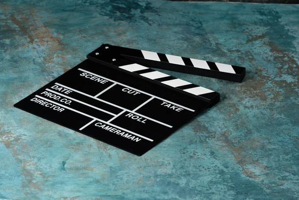 Clapper board with popcorn. Movie concept. Clapperboard on a textural background. Close-up. - Fotó, kép