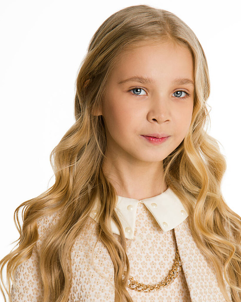 Photo beautiful blonde girl with long hair in curls. Stylish fashionable classic clothes. look at the camera. White background. Isolated. School girl 8-10 years old. Perfect school look. Honours pupil - Foto, Imagem