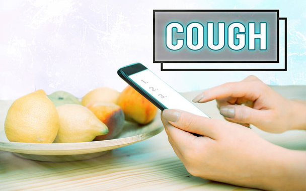 Conceptual hand writing showing Cough. Business photo text sudden expulsion of air throughout the passages to clear airways Modern gadgets white screen under colorful bokeh background. - Photo, Image