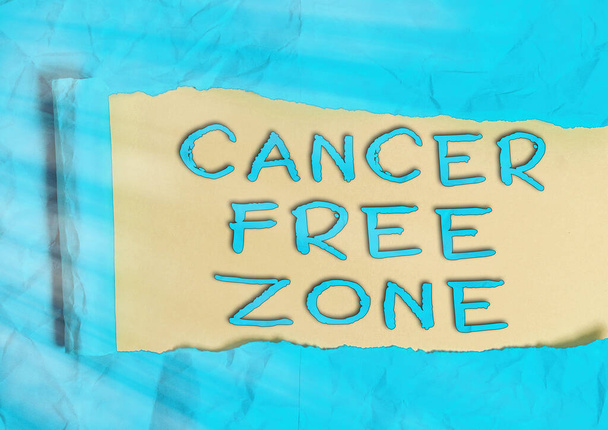 Word writing text Cancer Free Zone. Business concept for supporting cancer patients and raising awareness of cancer Rolled ripped torn cardboard placed above a wooden classic table backdrop. - Photo, Image