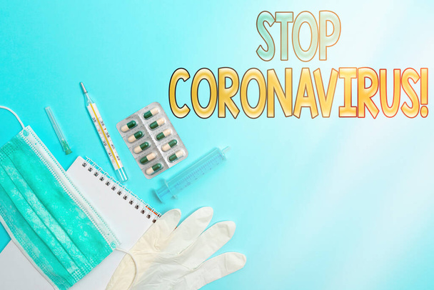 Writing note showing Stop Coronavirus. Business photo showcasing Disease awareness campaign fighting to lessen the COVID19 cases Set of medical equipment with notepad for health condition assessment. - Photo, Image