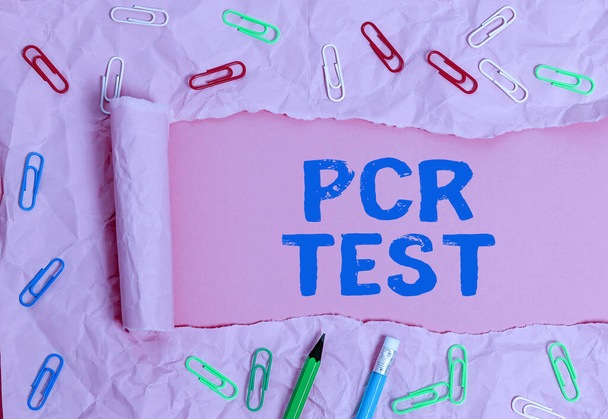 Conceptual hand writing showing Pcr Test. Business photo showcasing qualitative detection of viral genome within the short seqeunce of DNA Rolled ripped torn cardboard above a wooden classic table. - Photo, Image