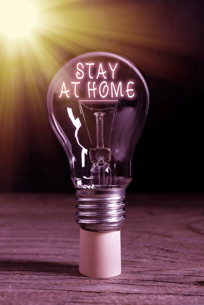 Word writing text Stay At Home. Business concept for movement control restricting individuals from getting exposed publicly Realistic colored vintage light bulbs, idea sign solution thinking concept. - Photo, Image