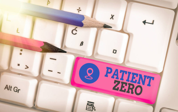 Writing note showing Patient Zero. Business photo showcasing primary disease carrier of the highlycontagious disease White pc keyboard with empty note paper above white key copy space. - Photo, Image