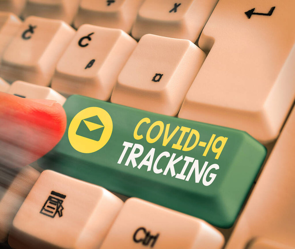 Text sign showing Covid 19 Tracking. Conceptual photo Distinguishing process of the possible infected individuals White pc keyboard with empty note paper above white key copy space. - Photo, Image