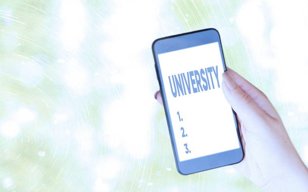 Handwriting text writing University. Concept meaning an educational institution designed to teach and investigate Modern gadgets with white display screen under colorful bokeh background. - Photo, Image