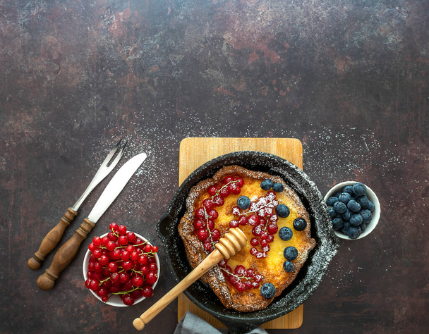 Dutch baby pancake in iron cast pan. - Fotoğraf, Görsel