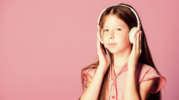 Concentrated teenager. small girl pupil in headphones. girl listen to music. Audio book. back to school. study online. E learning with ebook. self education. Mp3 player. home schooling. copy space - 写真・画像
