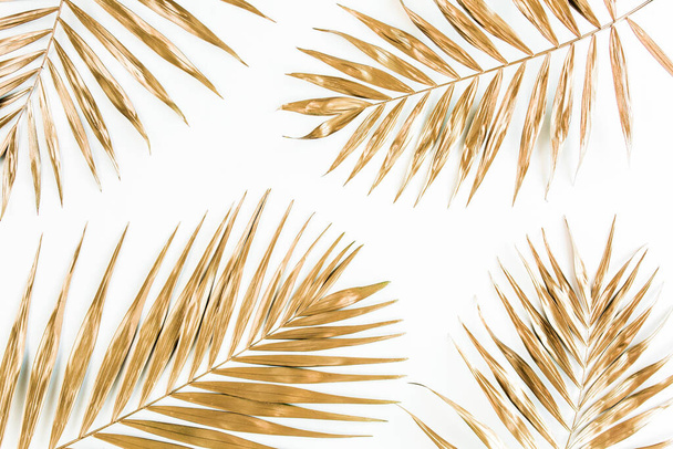 Gold tropical palm leaves on white background. Flat lay, top view minimal concept. - Фото, изображение