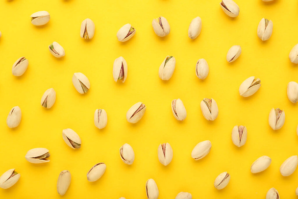 Tasty pistachios on yellow background - Foto, imagen